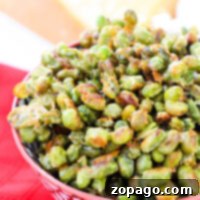 Dry Roasted Edamame 5 A bowl of dried edamame sits invitingly on a red patterned tablecloth, offering a tasty and nutritious snack.