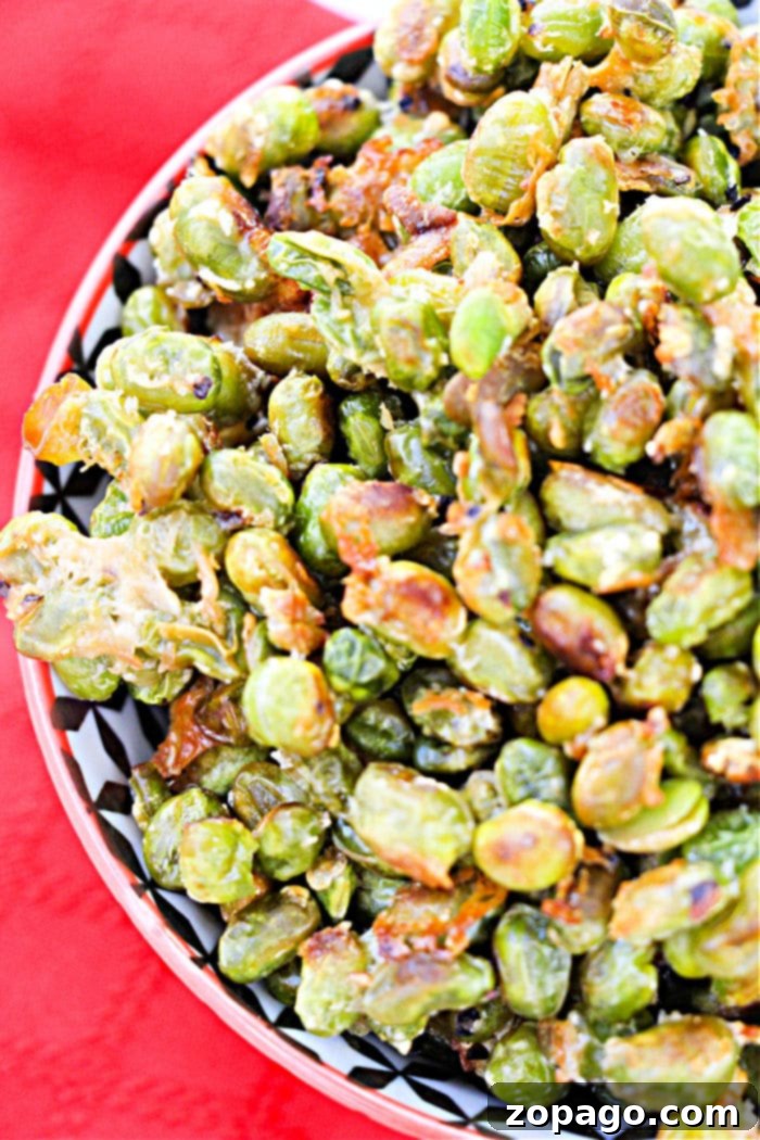 Dry Roasted Edamame 7 A vibrant bowl of crispy dried edamame on a rustic wooden table