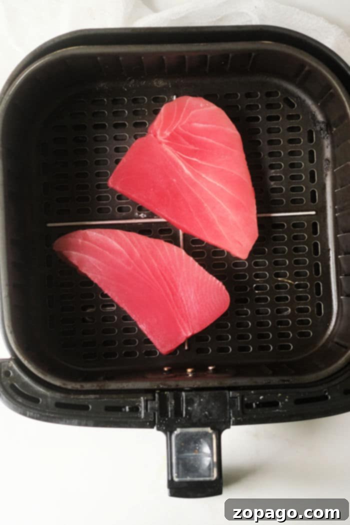 Air Fryer Tuna Steaks 4 Close-up of a beautifully seared air fryer tuna steak, showcasing its vibrant pink interior.