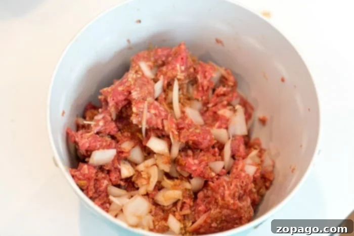 Simple Weeknight Meatloaf 3 Mixing meatloaf ingredients in a large bowl for the best flavor