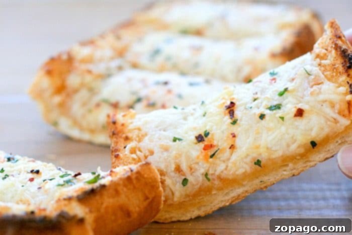 Irresistible Roasted Garlic Bread 5 Slices of spicy garlic bread on a board, ready to be served
