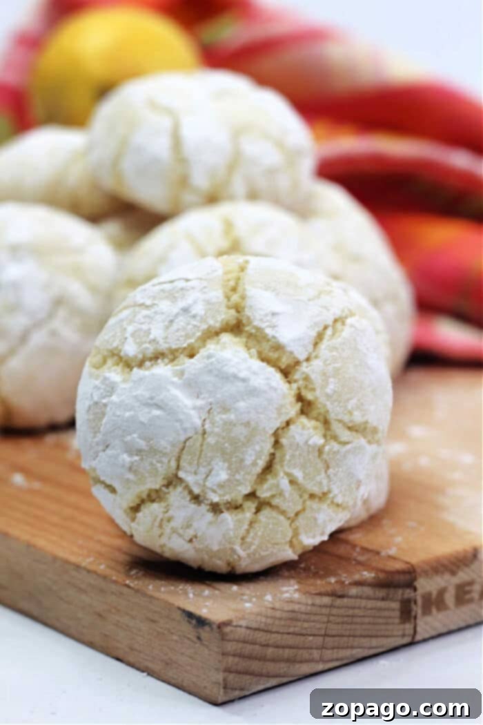 Zesty Lemon Crinkle Cookies 2 Freshly baked lemon crinkle cookies with cream cheese, beautifully dusted with powdered sugar and ready to be enjoyed. A perfect treat for any occasion.