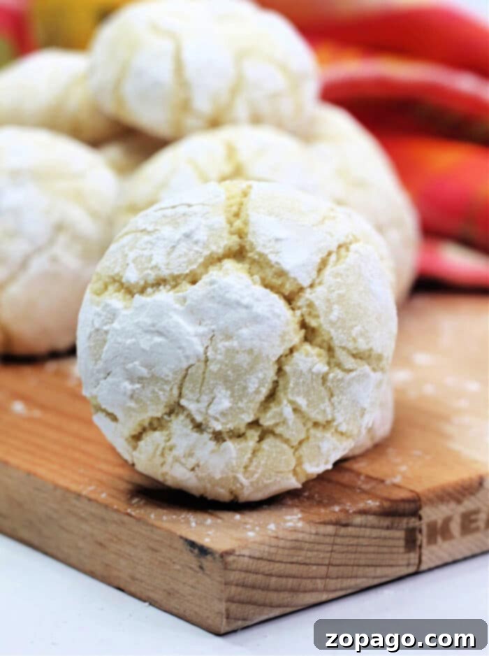 Zesty Lemon Crinkle Cookies 8 A vibrant display of freshly baked lemon crinkle cookies, dusted with powdered sugar, creating a delicious and inviting scene.