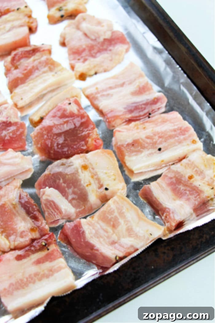 Crispy Oven-Baked Pork Belly 5 Pork belly perfection is achieved by arranging slices of pork belly in the oven.