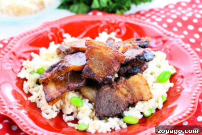 Succulent and Crispy Oven Pork Belly 8 Delicious pork belly recipe served on a plate with fresh greens.