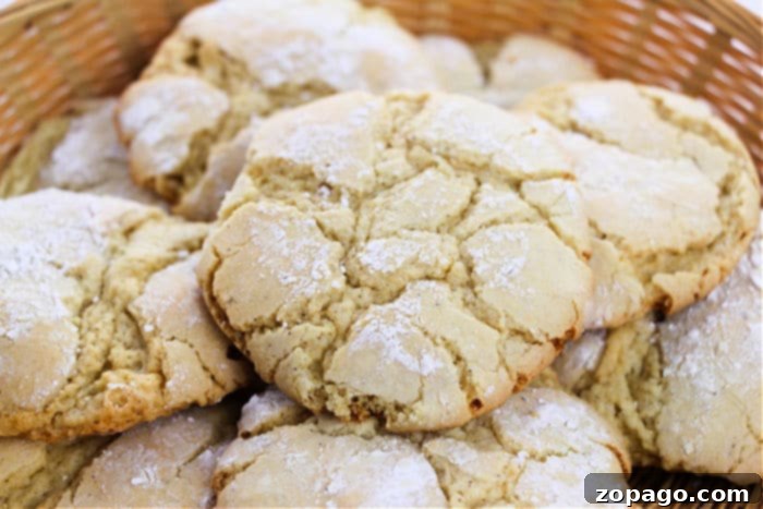 Three-Ingredient Cake Mix Cookie Magic 7 A stack of vanilla crinkle cookies, coated in powdered sugar, ready to be served.