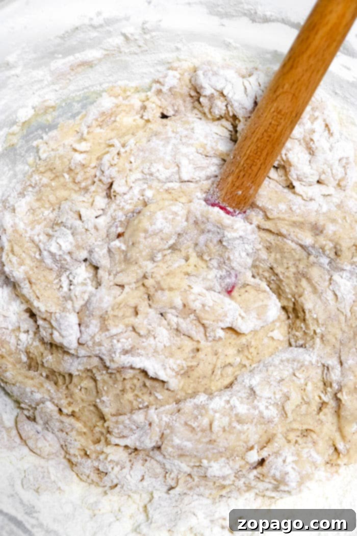 Cinnamon Swirl Muffins 3 Close-up of fluffy, golden muffin batter in a mixing bowl, ready for baking.