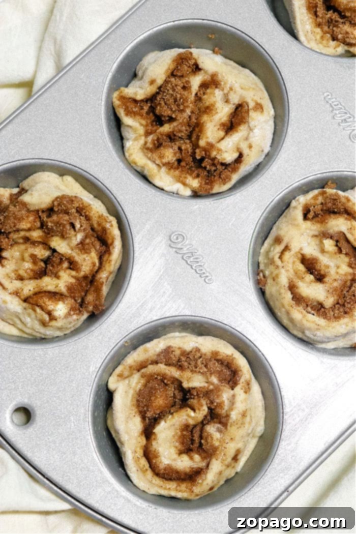 Cinnamon Swirl Muffins 5 Freshly baked homemade cinnamon roll muffins with a generous drizzle of white glaze.