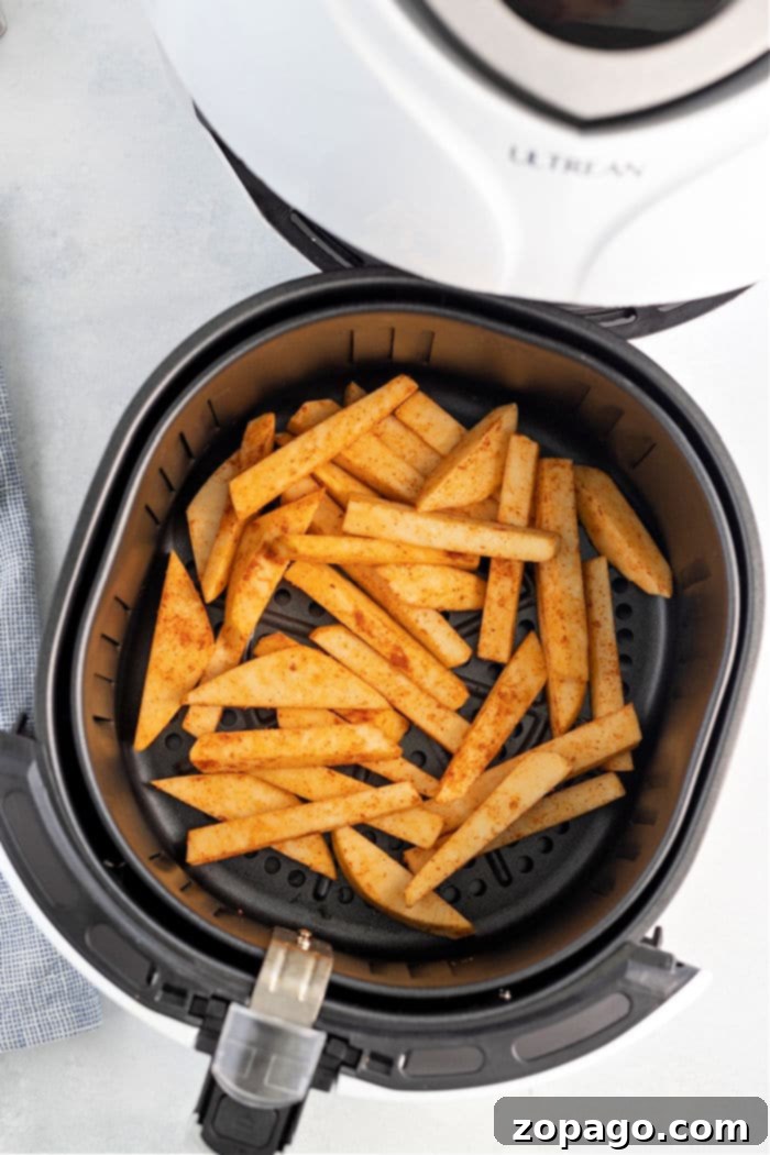 Crispy Turnip Fries 6 An open air fryer basket filled with seasoned, cut potato fries, with "Ultrean" visible on the lid. This appliance is perfect for making delicious air fryer turnip fries.
