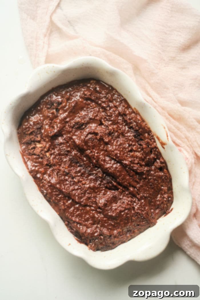 Decadent Chocolate Gingerbread Cake 5 A whole chocolate gingerbread cake on a cooling rack, showing its dark, rich crust, freshly baked and aromatic.