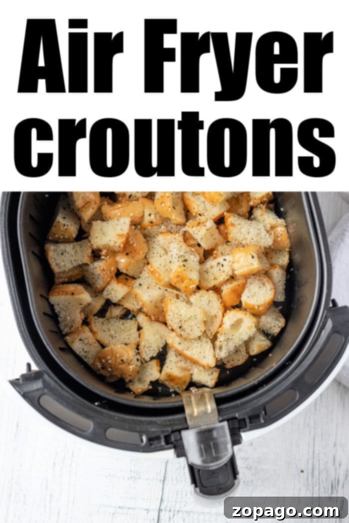 Ultimate Air Fryer Croutons 4 A crisp air fryer basket brimming with golden, seasoned croutons sits on a pristine white background. Text elegantly announces: Air Fryer Croutons.