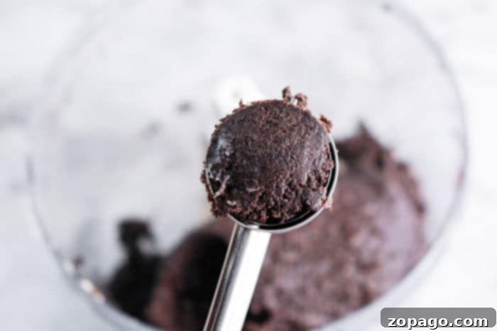 How the Grinch Stole Dessert 3 A scoop of rich dark chocolate cookie dough, ready to be transformed into a festive Grinch dessert.