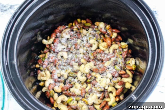 Cheesy Crunch Mix 6 A generous serving of slow cooker Chex mix, featuring a rich blend of nuts, crispy Chex cereal, and cheesy crackers, in a rustic bowl.