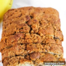 Close-up of a loaf of banana bread with a crumbly, golden-brown crust, made effortlessly using a Bisquick banana bread recipe.