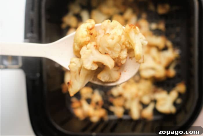Perfectly Tender Air Fryer Frozen Cauliflower 7 Cooked air fryer frozen cauliflower ready to serve on a plate