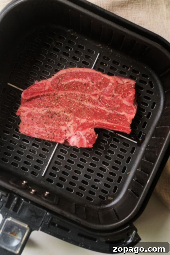 Perfect Air Fryer Lamb Chops 6 Close-up photo of air fryer lamb chops resting on a cutting board after cooking