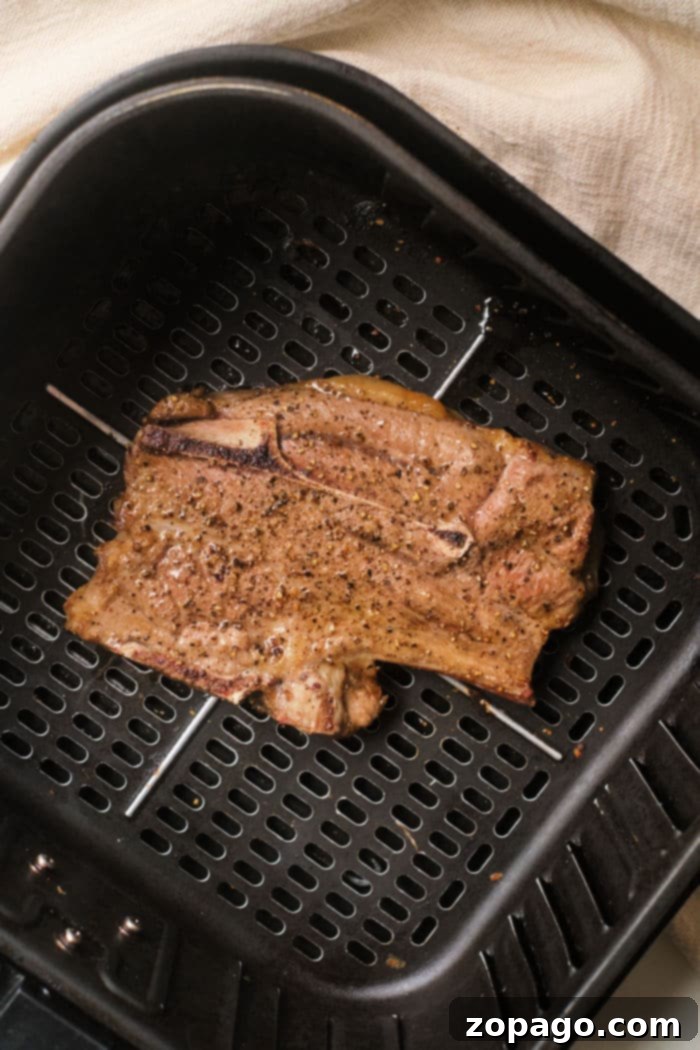 Perfect Air Fryer Lamb Chops 8 Perfectly cooked lamb chops showcased in an air fryer basket, ready to be served