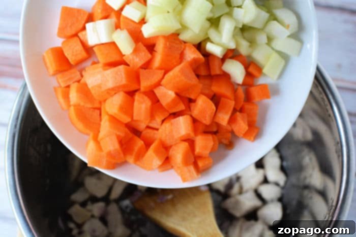 Hearty Instant Pot Chicken Vegetable Soup 5 A colorful array of chopped vegetables, including potatoes, carrots, and celery, ready for Instant Pot vegetable soup.