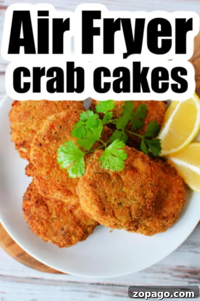 Golden Crispy Air Fryer Crab Cakes 9 A beautifully plated dish of Air Fryer Crab Cakes, artfully garnished with fresh cilantro and bright lemon wedges, ready to be enjoyed. The title 'Air Fryer Crab Cakes' is prominently displayed, inviting viewers to explore the recipe.