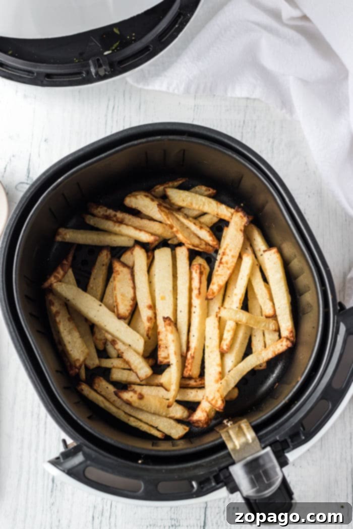 Crispy Jicama Fries 5 cooked jicama fries in a bowl with a side of ketchup, ready to be served.