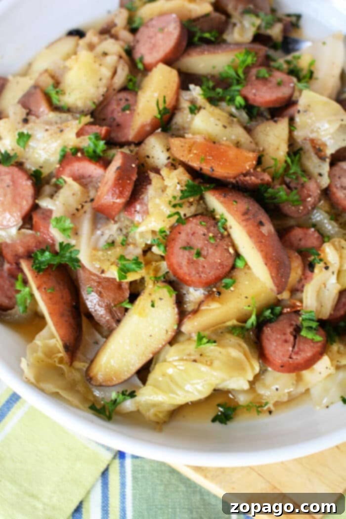 Hearty Slow Cooker Cabbage and Sausage 10 A close-up of a Haluski-style dish, featuring tender cabbage and noodles (or potatoes in this variation) with savory sausage.