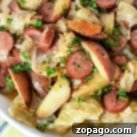 Hearty Slow Cooker Cabbage and Sausage 4 A vibrant image showcasing sausage, potatoes, and perfectly seasoned crockpot cabbage in a bowl.
