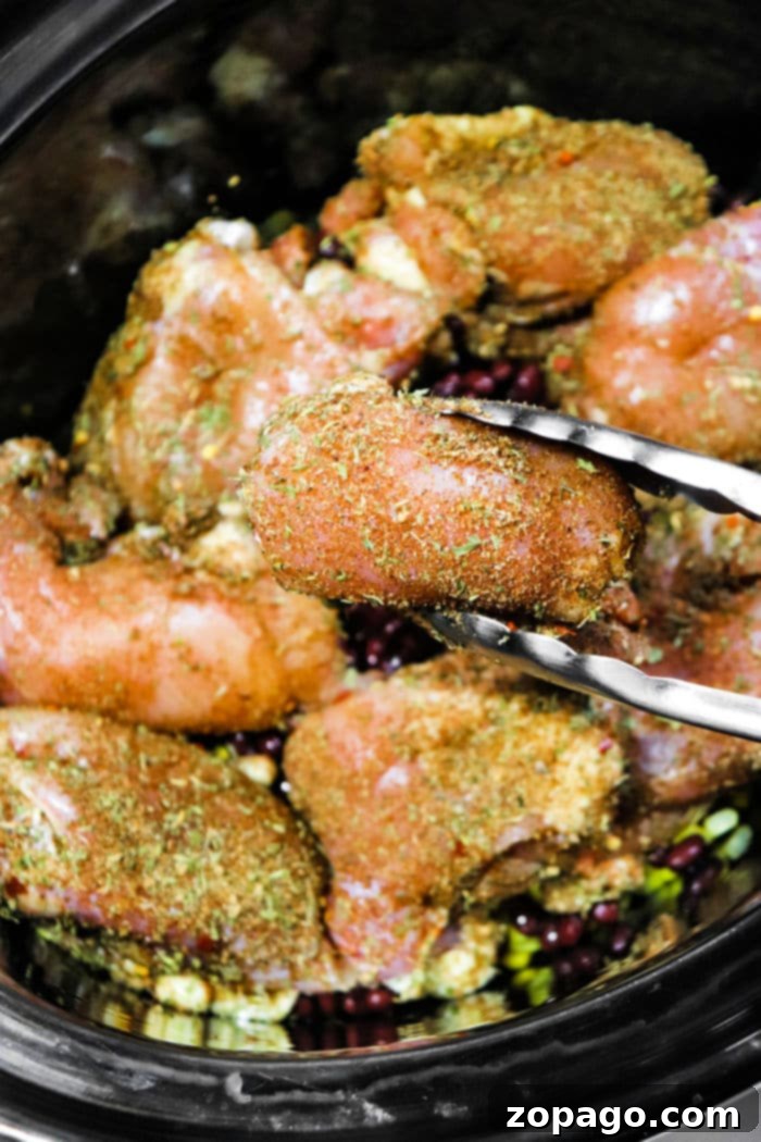 Effortless Slow Cooker Jerk Chicken 6 Close-up of slow cooker jerk chicken, glistening with sauce and spices, highlighting its tenderness.
