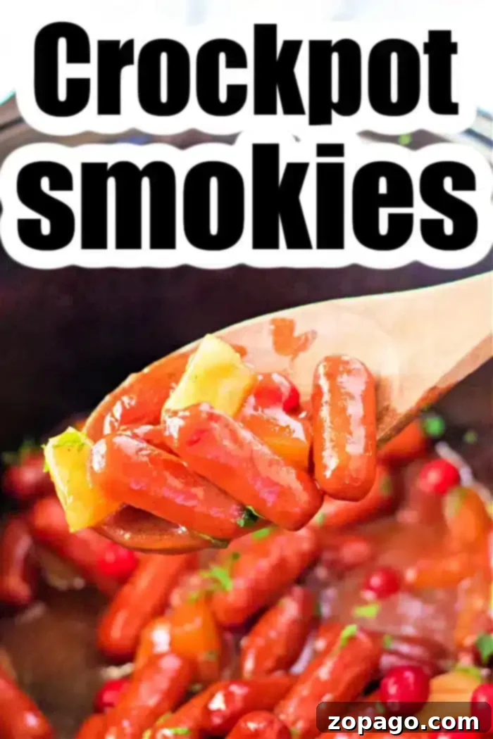 Sweet and Sticky Slow Cooker Sausages 6 A wooden spoon holds cocktail sausages, pineapple chunks, and cherries above a crockpot. The text "Crockpot Little Smokies Recipe" is prominently displayed at the top, inviting you to try this delightful dish.