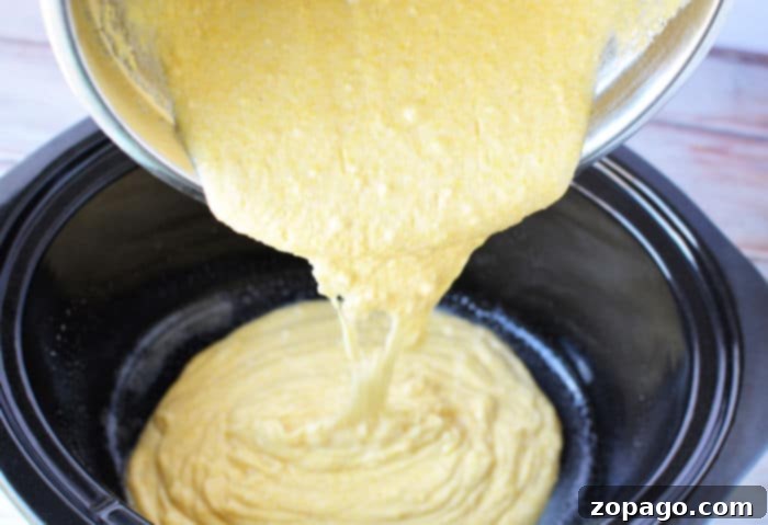 Effortless Slow Cooker Cornbread 4 Sliced Crockpot cornbread in a slow cooker, showing a moist interior and golden crust.