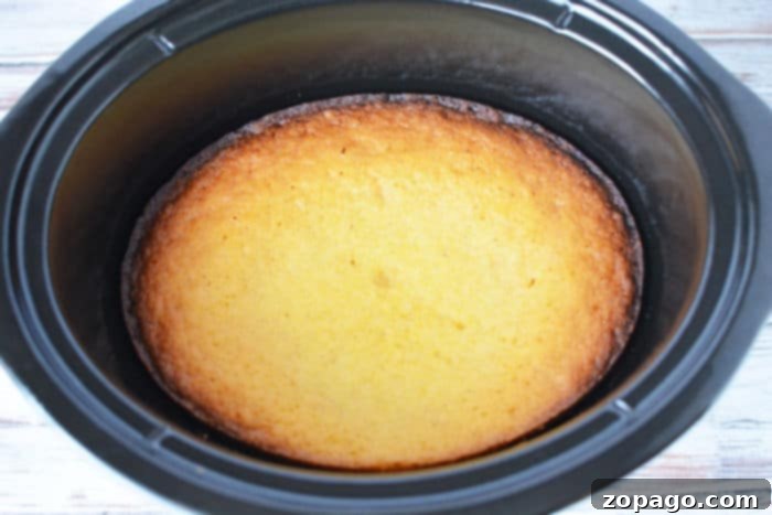 Effortless Slow Cooker Cornbread 6 Sliced slow cooker cornbread on a plate, showing its soft and fluffy texture.