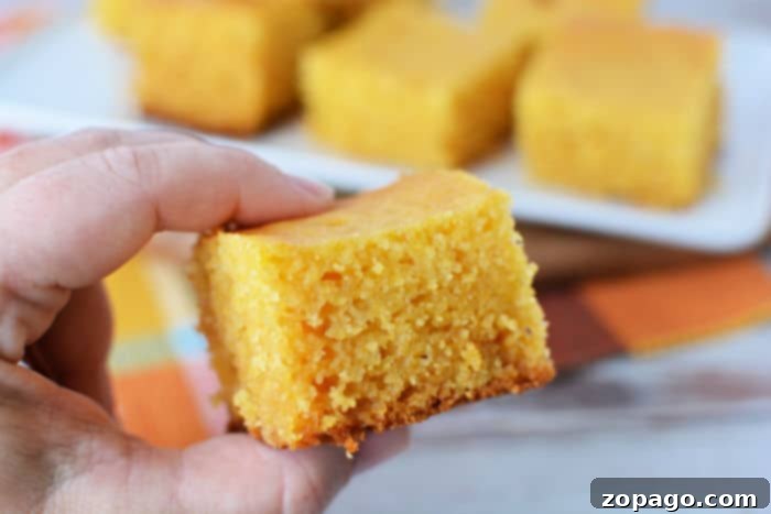 Effortless Slow Cooker Cornbread 8 Stacked pieces of Jiffy cornbread, showing a golden crust and soft texture, ready to be eaten.