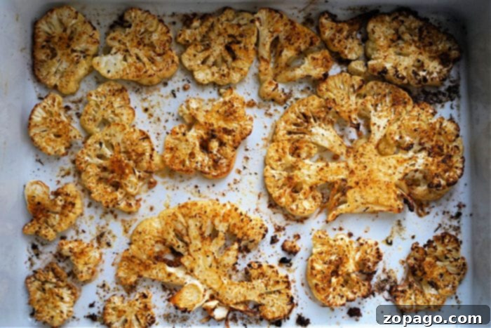 Perfectly Crisped Air Fryer Cauliflower Steaks 5 Close-up of golden-brown air fryer cauliflower steaks garnished with fresh herbs