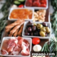 A charcuterie board shopping list featuring meats, cheeses, olives, nuts, and dips, all elegantly garnished with rosemary sprigs.
