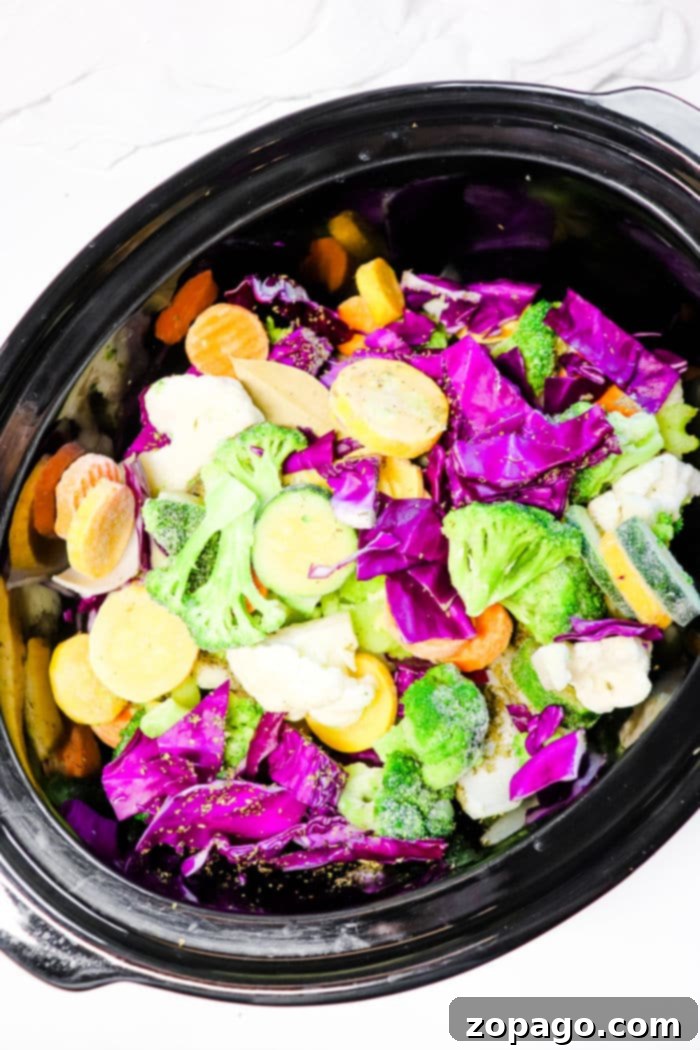 Vibrant Slow Cooker Purple Cabbage Soup 5 A large pot of slow cooker Cabbage Soup, filled with colorful vegetables and a rich broth, invitingly steaming on the countertop.