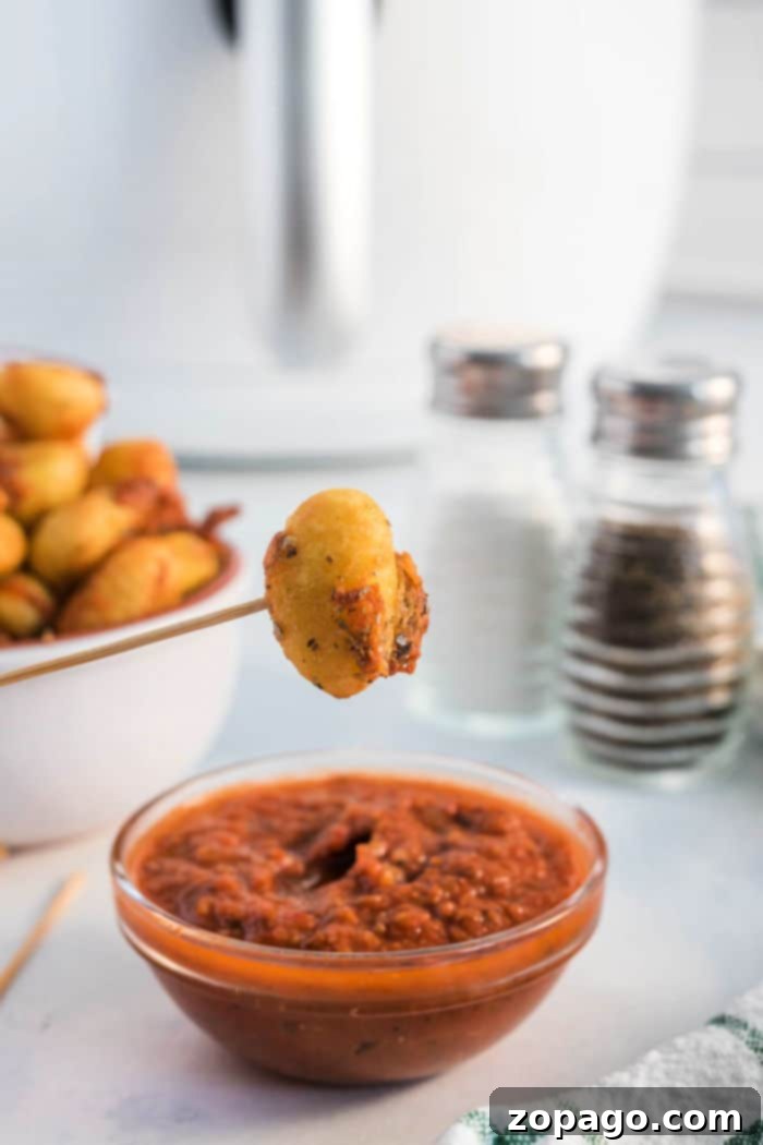 Crispy Ninja Foodi Air Fryer Gnocchi 6 Air fried pizza gnocchi served with a side of marinara sauce, perfect for dipping.