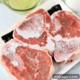 Perfectly Cooked Steak, From Frozen 7 Three frozen steaks rest on a white tray, waiting to be transformed into a culinary delight. A bowl of olive oil sits nearby, ready for the first step in learning how to cook frozen steak to perfection.