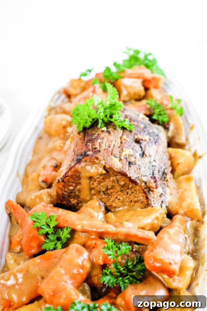 Effortless Slow Cooker Sirloin Roast 2 Delicious slow-cooked sirloin tip roast with carrots, potatoes, and savory gravy, ready to be served from the crockpot