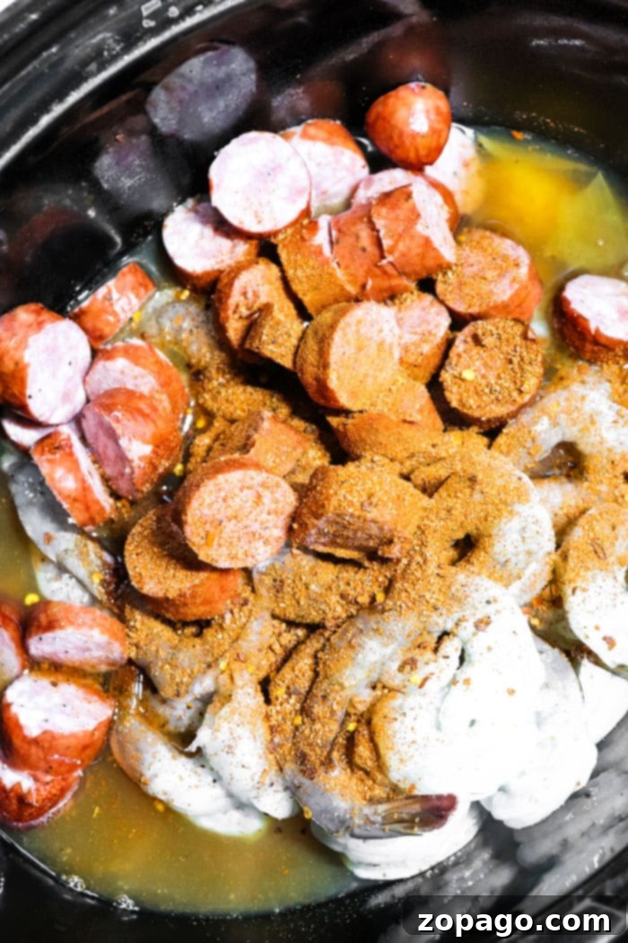 Easy Slow Cooker Shrimp Boil 5 A vibrant slow cooker shrimp boil filled with orange shrimp, golden corn, and white potatoes.