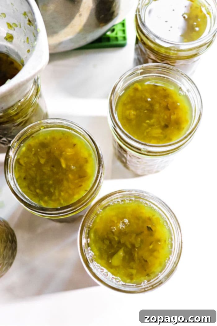 Sweet Heat Pepper Jelly 5 Guide to water bath canning, with sealed jars of jelly in a large pot.