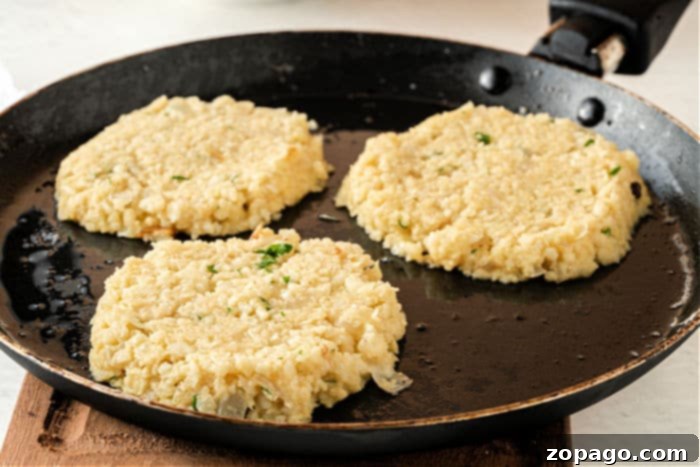 Savory Cauliflower Fritters 7 Crispy air-fried cauliflower fritters on a plate, showcasing a delicious low-carb and Keto recipe.