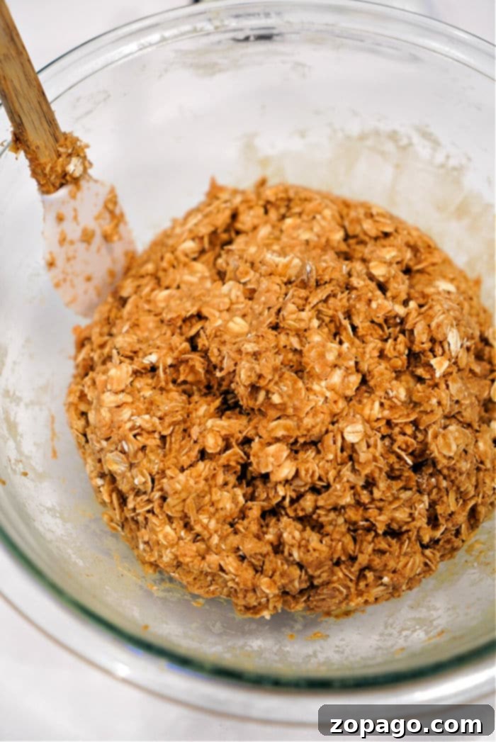 Viral TikTok Oatmeal Bars 4 A tray of no-bake peanut butter bars being prepared, showing the even layer before cutting.