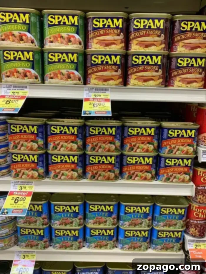 Crispy Air Fryer Spam Fries 4 Shelves stocked with various flavors of Spam, including Spam Fries, Jalapeño, Hickory Smoke, 25% Less Sodium, and Lite. Price tags and promotions are visible beneath the cans.