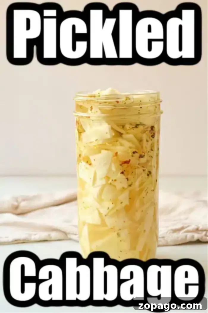 Speedy Tangy Cabbage 4 A clear glass mason jar of quick pickled cabbage rests on a light surface. Inside, vibrant sliced cabbage is suspended in a yellowish pickling brine. The image prominently features the words "Quick Pickled Cabbage" as an overlay, with a subtly blurred background cloth, enhancing its rustic charm.