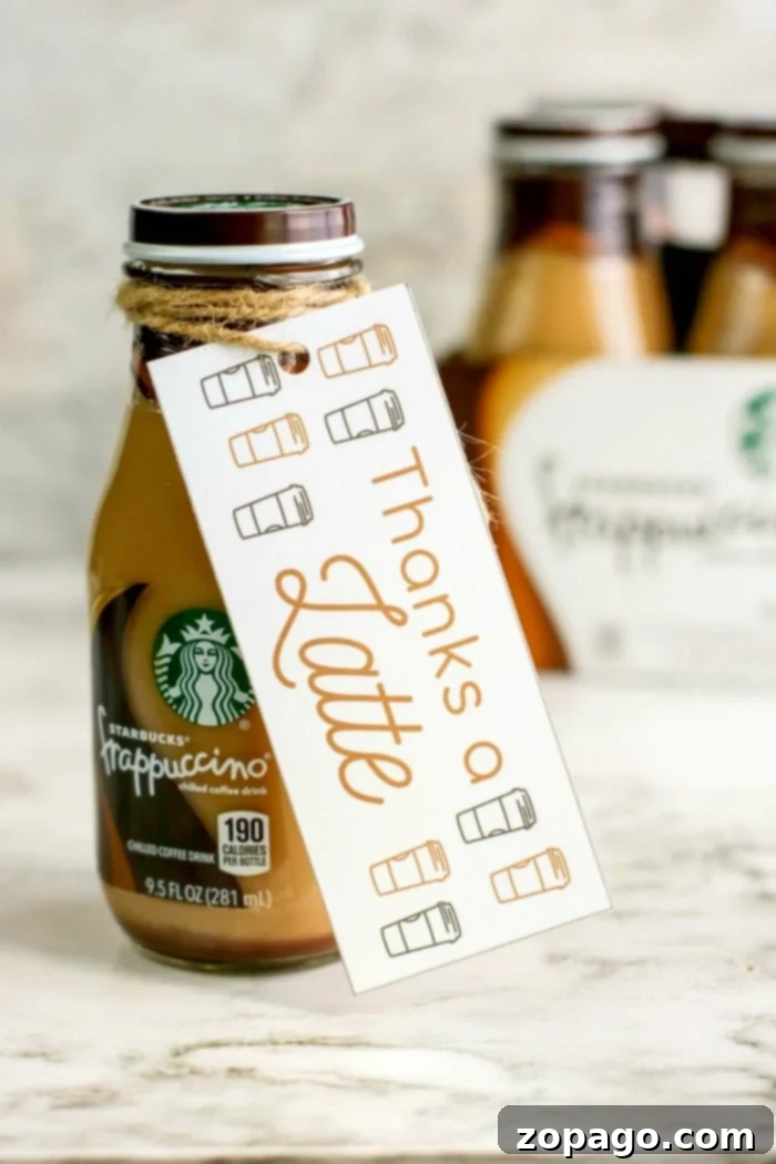 DIY Thank You Tags for Teachers 3 A bottled Starbucks Frappuccino with a label tied around its neck. The label reads "Thanks a Latte" with charming coffee cup illustrations, making it a perfect appreciation gift idea. A blurred background features more bottles, adding to the delightful display.