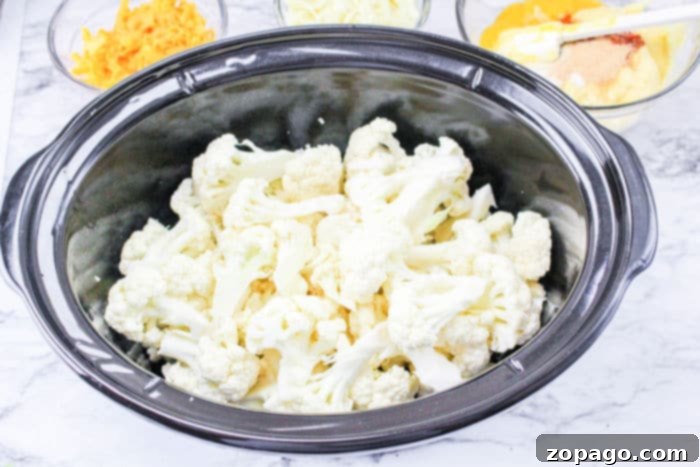 Slow Cooker Cheesy Cauliflower Mac and Cheese 5 cauliflower in slow cooker with sauce