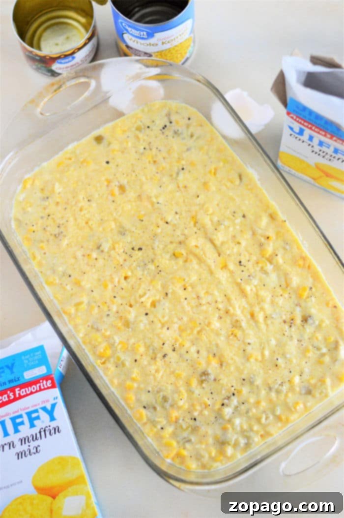 Quick Mexican Cornbread 11 Glass dish with Jiffy Mexican Cornbread. Nearby are cans and a box of corn muffin mix on the countertop.