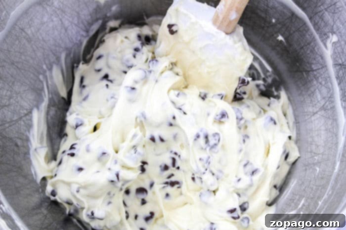Philly Cream Cheese Dessert Dip 5 Ingredients for cream cheese dip being mixed in a bowl