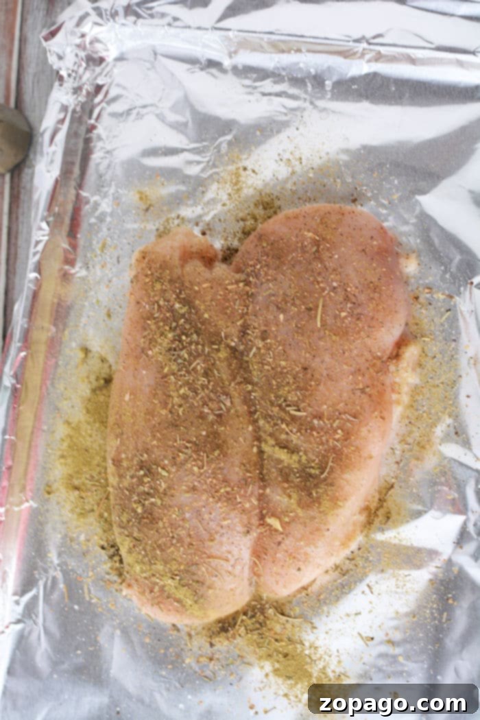 Effortless Oven-Baked Frozen Chicken Breast 7 A perfectly cooked frozen chicken breast, golden brown and juicy, ready to be sliced, emphasizing a successful oven cooking method.