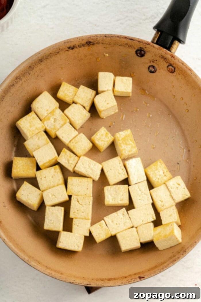 Crispy Tofu Bites 10 Baked Tofu Nuggets with Nutritional Yeast, perfectly golden and inviting, ready to be served.