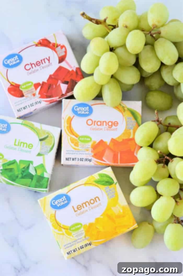 Grape Lollipops 3 Four boxes of Great Value Gelatin Dessert in Cherry, Orange, Lime, and Lemon flavors are displayed alongside a bunch of green grapes on a light surface. Each colorful box has a net weight of 3 ounces (85 grams), highlighting their jello flavors.